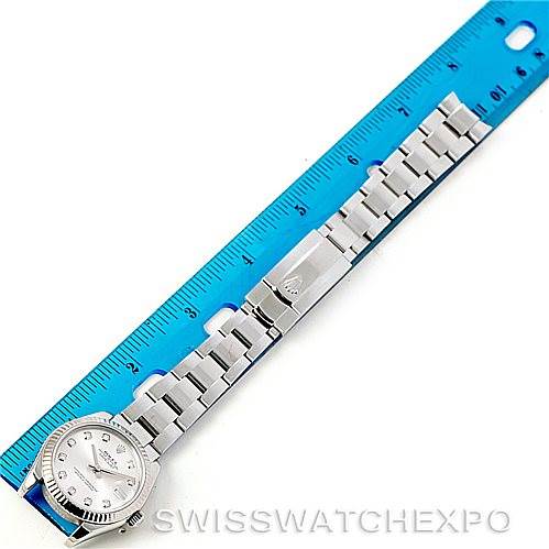 The image shows a Rolex Mid-Size 178274 Women's Stainless Steel Silver Dial 178274 Women's Stainless Steel Silver Dial watch taken from a top-down angle, displaying the entire watch alongside a blue ruler for scale.