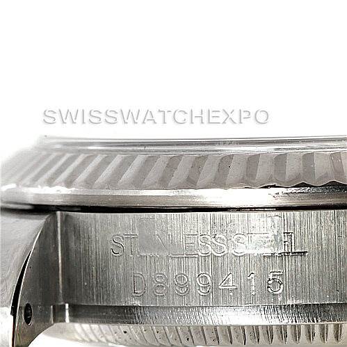 The image shows a close-up of the bezel and side of a Mid-Size Rolex watch with visible engraved model and serial numbers.