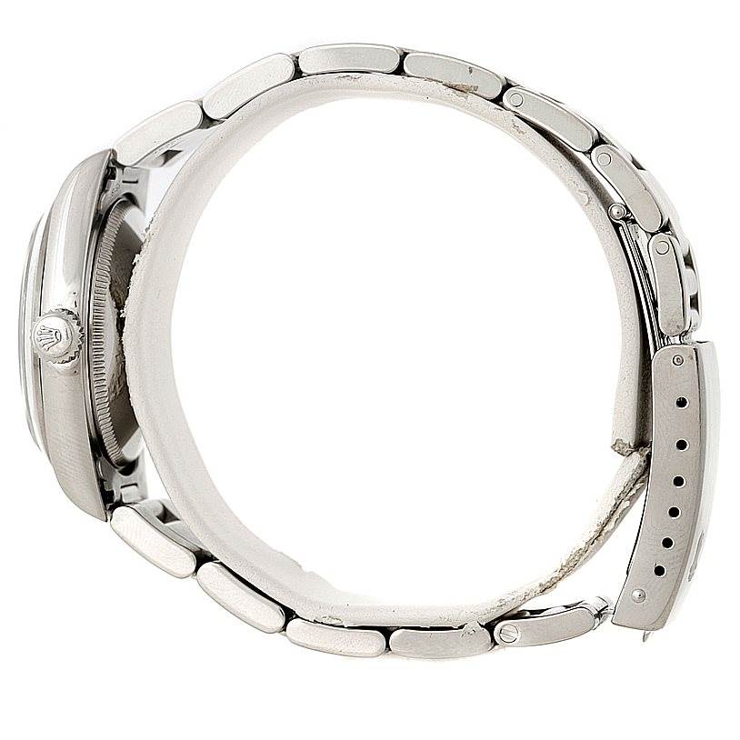 The image shows a side view of a Rolex Mid-Size 77080 Women's Stainless Steel Blue Dial 77080 Women's Stainless Steel Blue Dial model watch, focusing on the bracelet, clasp, and crown.