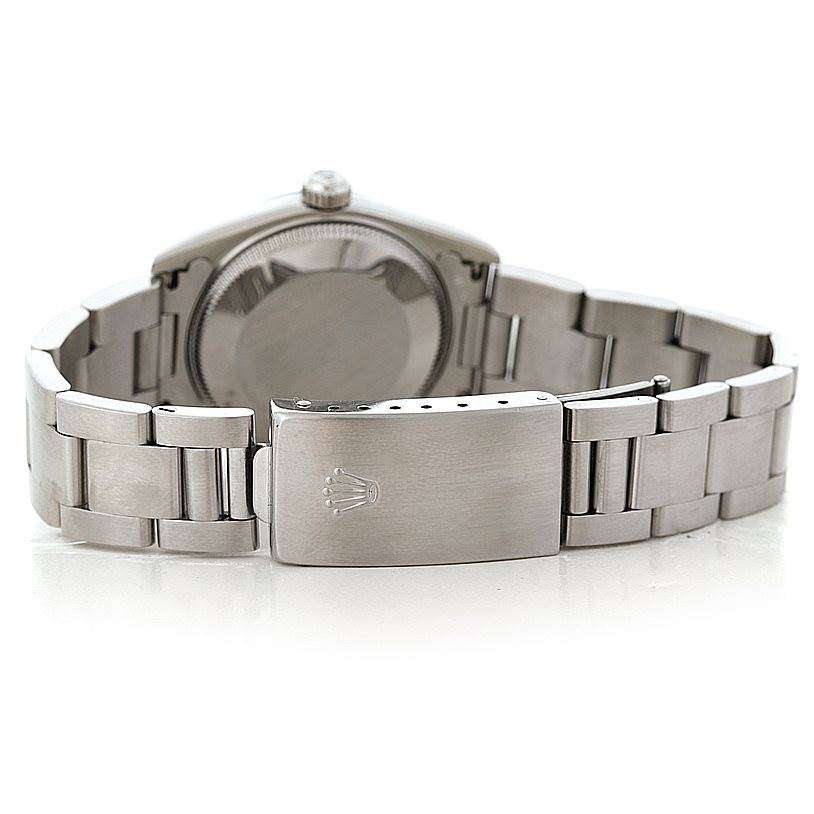 This image shows the back view of a mid-size Rolex watch, focusing on the case back and the bracelet clasp.