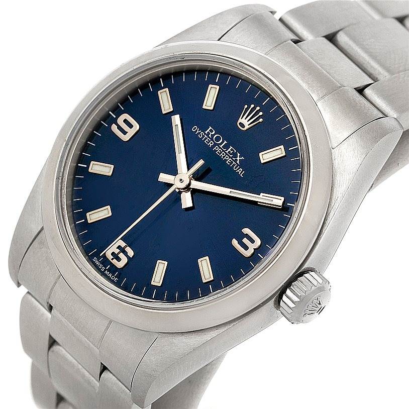 This image shows a close-up of the dial, bezel, crown, and bracelet of the Mid-Size Rolex Oyster Perpetual watch.