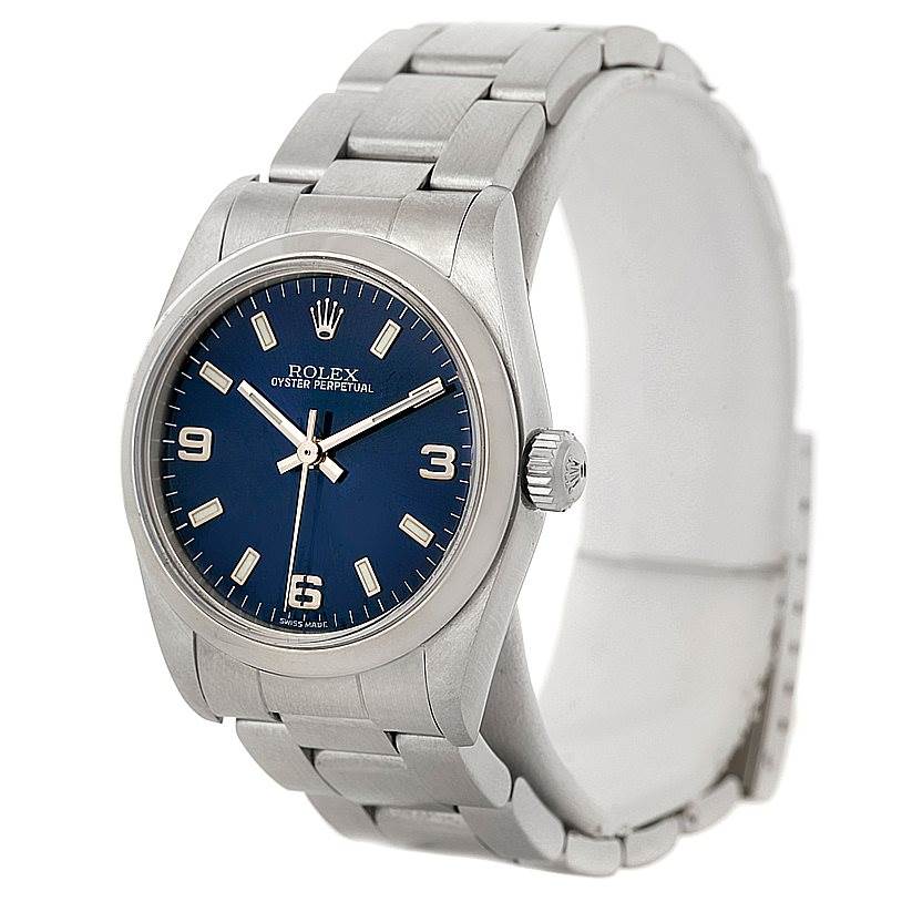 The Rolex Mid-Size 77080 Women's Stainless Steel Blue Dial 77080 Women's Stainless Steel Blue Dial model watch is shown at a three-quarter angle, displaying the face, bezel, crown, and bracelet.