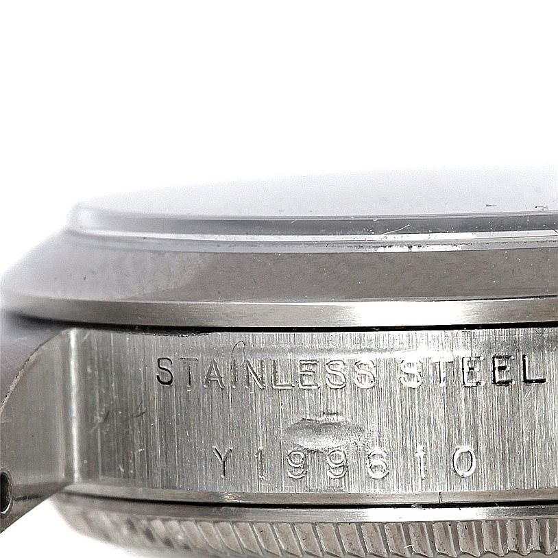 The image shows a close-up side view of a Rolex Mid-Size 77080 Women's Stainless Steel Blue Dial 77080 Women's Stainless Steel Blue Dial watch, highlighting the stainless steel case and serial number.