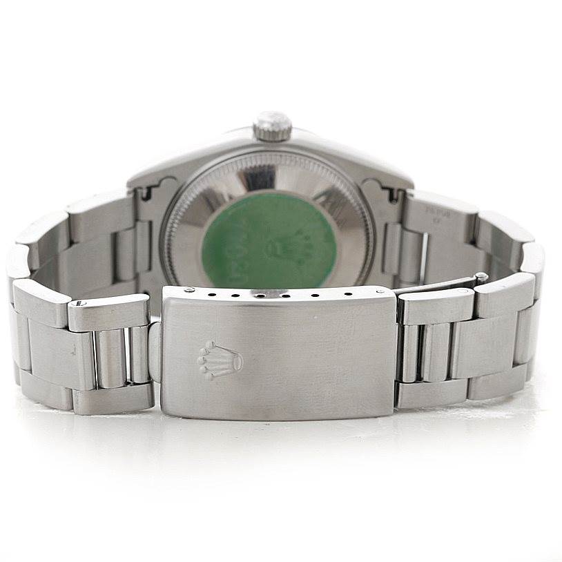 The image shows the back and clasp of a Rolex Mid-Size 77080 Women's Stainless Steel Pink Dial 77080 Women's Stainless Steel Pink Dial model watch, highlighting its bracelet and case back.