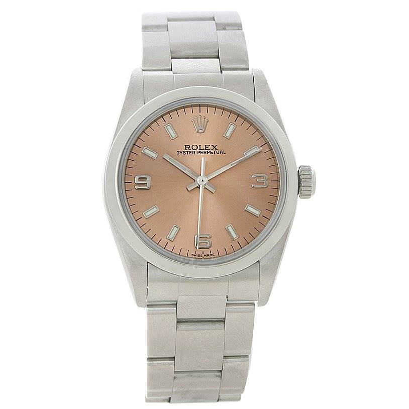 The image shows a front view of a Rolex Mid-Size 77080 Women's Stainless Steel Pink Dial 77080 Women's Stainless Steel Pink Dial Oyster Perpetual watch, highlighting its dial, case, and bracelet.