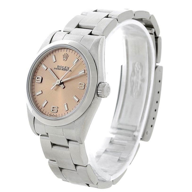 The image shows a side-angled view of a Rolex Oyster Perpetual Mid-Size watch, highlighting the face, crown, and bracelet.