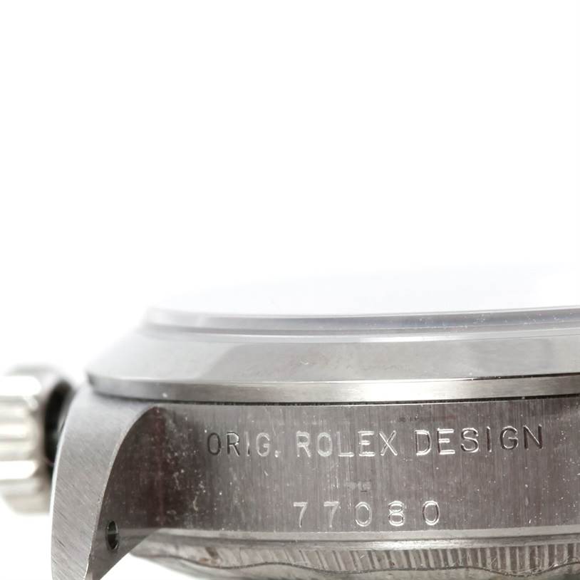 This image shows a side view of the casing and crown of a Rolex Mid-Size 77080 Women's Stainless Steel Black Dial 77080 Women's Stainless Steel Black Dial watch, highlighting the engraved serial number and the "Orig. Rolex Design" inscription.