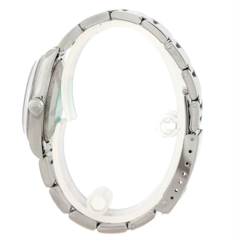 The image shows a side profile of a Rolex Mid-Size 77080 Women's Stainless Steel Black Dial 77080 Women's Stainless Steel Black Dial watch, featuring its bracelet, crown, and case.