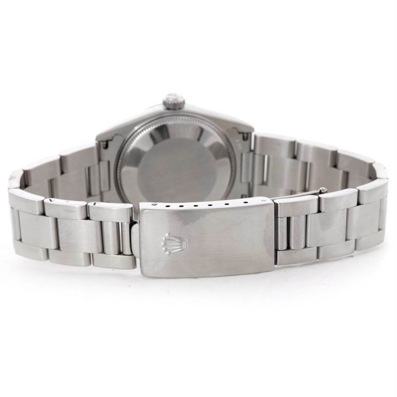 The image shows the back view of a Mid-Size Rolex watch, highlighting its bracelet and clasp.