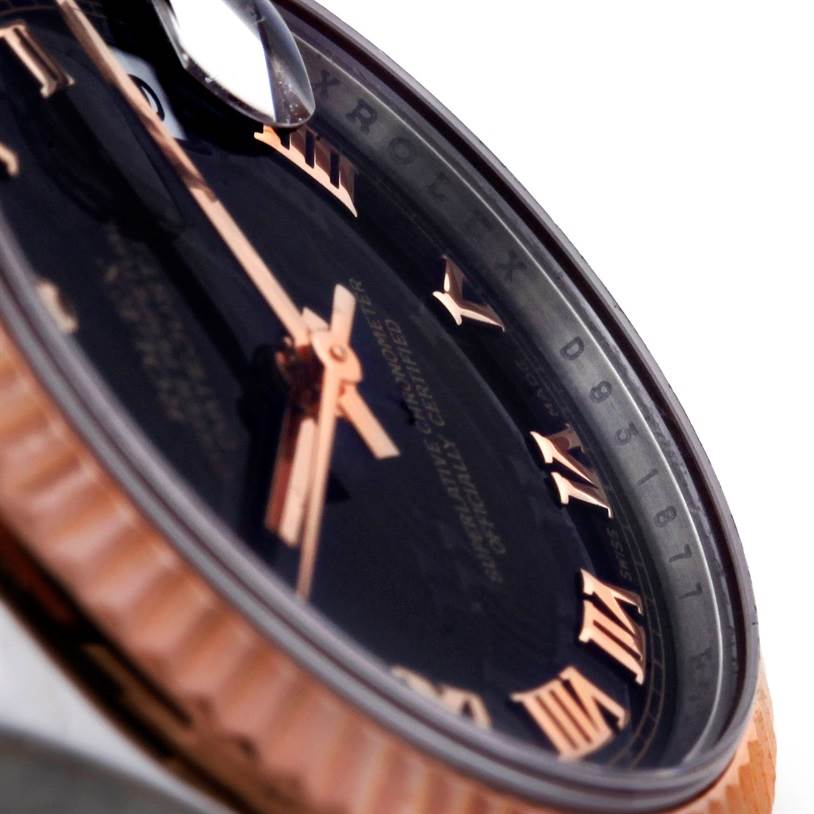 The image shows an angled close-up view of a Rolex Mid-Size 178271 Women's Steel and Gold (two tone) Black Dial 178271 Women's Steel and Gold (two tone) Black Dial watch, focusing on the dial with Roman numerals and the watch bezel.