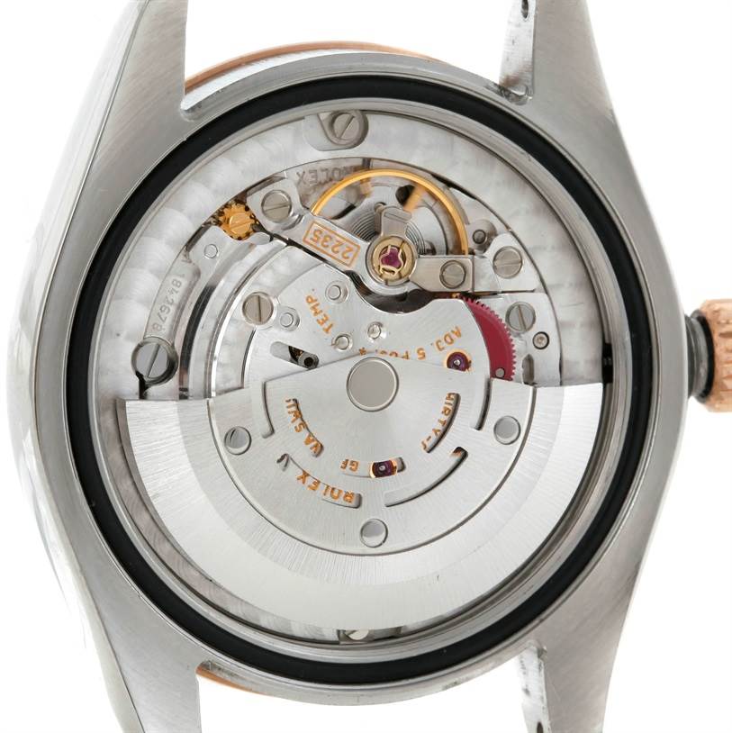 The image shows the internal mechanism of a Mid-Size Rolex watch, viewed from the back with the case removed.