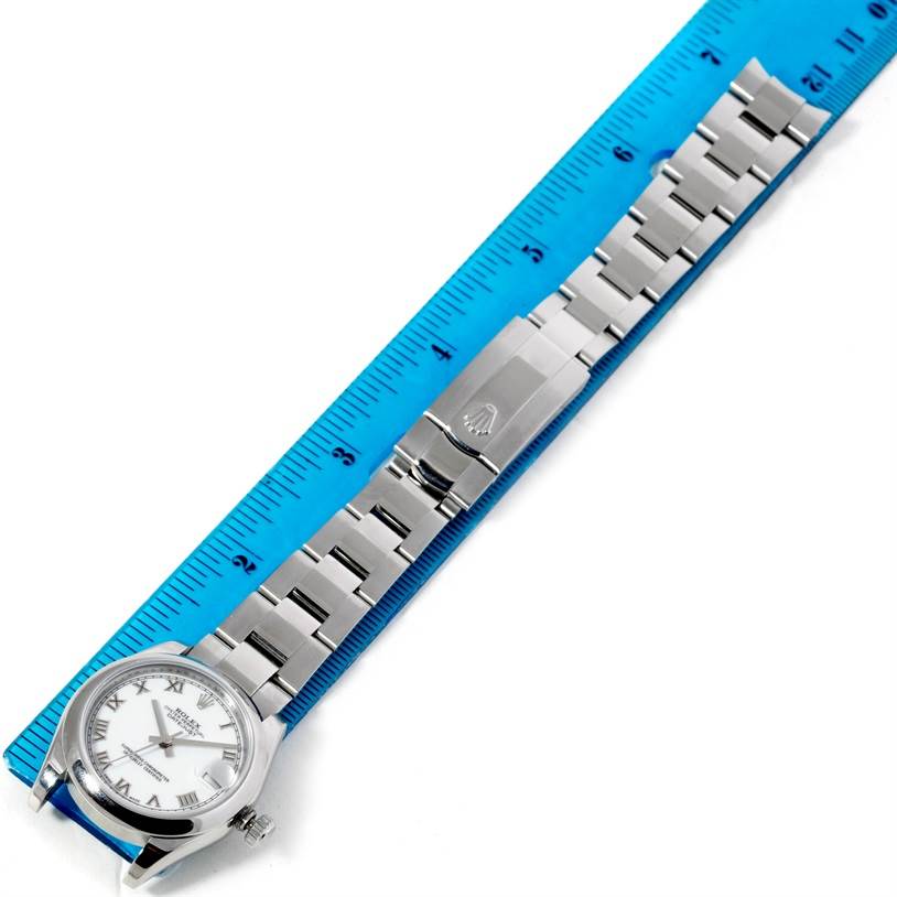 The image shows a top-down view of a Mid-Size Rolex watch with a metal bracelet and a blue ruler for scale.