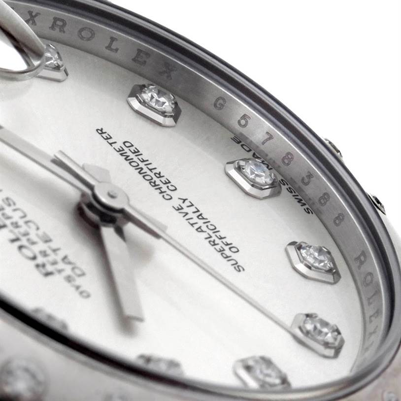 Close-up angle of the dial and bezel of a Mid-Size Rolex watch, showing the hands, indices, and text detailing.