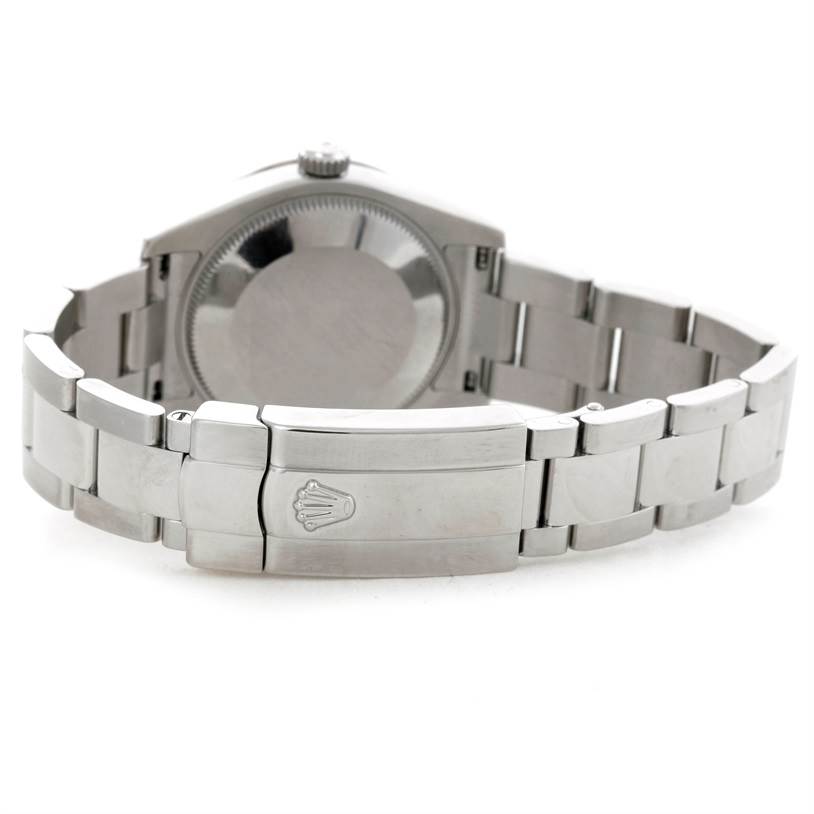 The image shows the back of a Mid-Size Rolex watch, highlighting the caseback and bracelet with the clasp featuring the Rolex logo.
