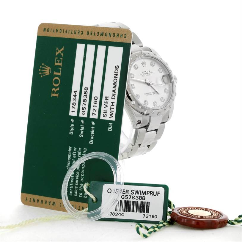 The image shows a Mid-Size Rolex watch with a silver dial featuring diamonds, accompanied by a certification card and tags.