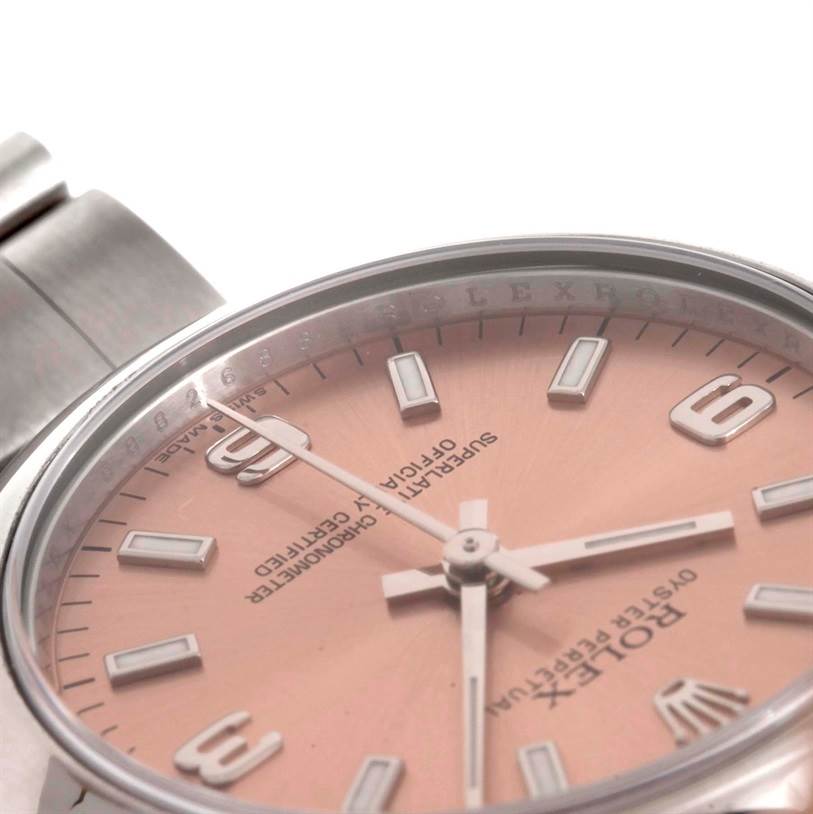 The image shows a close-up angled view of the dial and part of the case and bracelet of a Rolex Mid-Size 177200 Women's Stainless Steel Pink Dial 177200 Women's Stainless Steel Pink Dial watch.