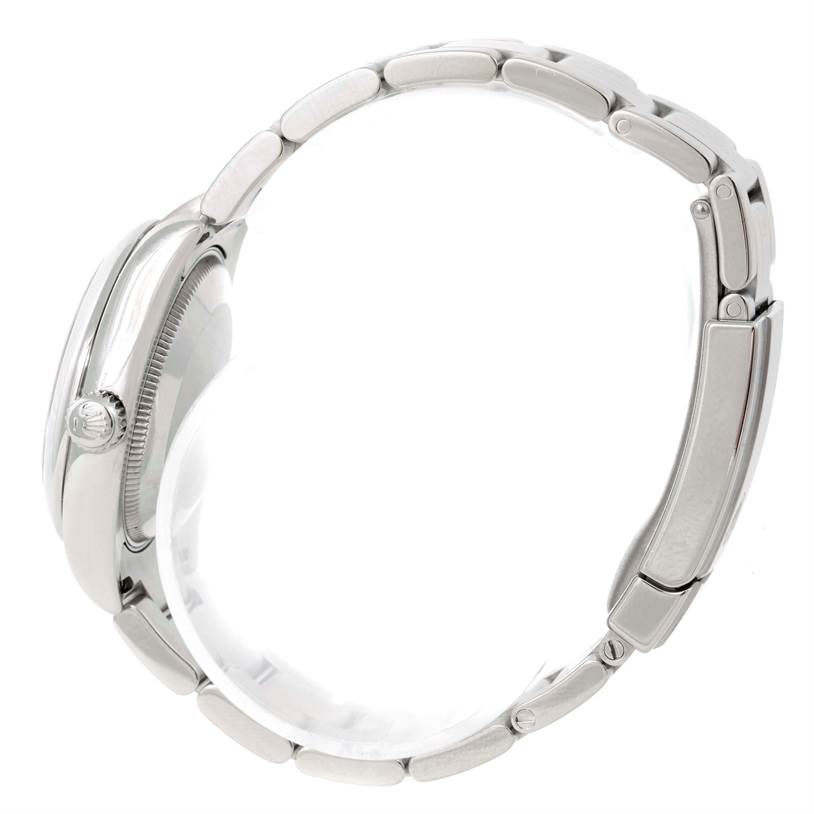 The image shows a side view of a mid-size Rolex watch, highlighting the crown, case, and bracelet.