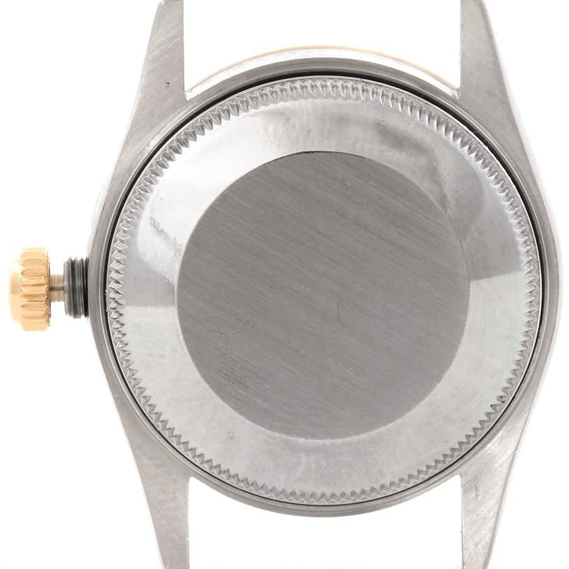 This image shows the back casing and crown of a Mid-Size Rolex watch from a top-down angle.