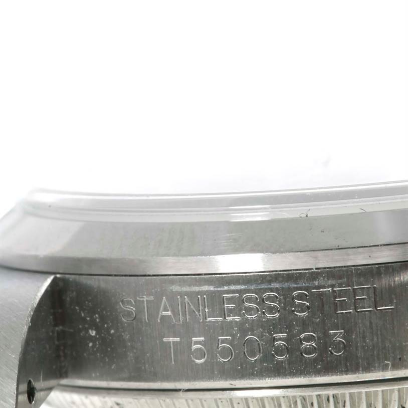 This image shows a close-up of the side of a Rolex Mid-Size 67480 Women's Stainless Steel Black Dial 67480 Women's Stainless Steel Black Dial stainless steel watch case with model number T550583.