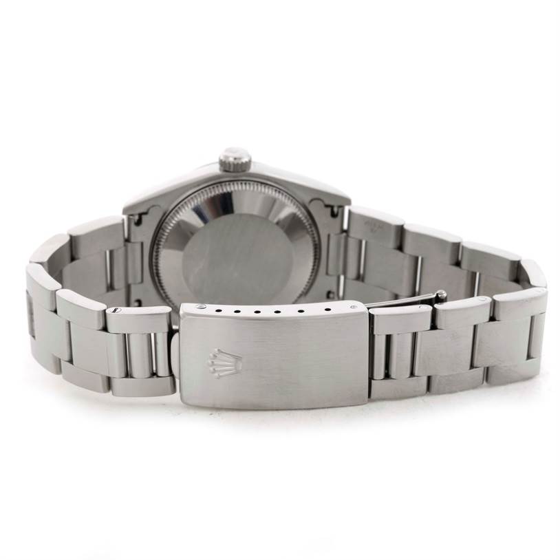 The image shows the back and clasp of a Mid-Size Rolex watch, highlighting the bracelet and case back.