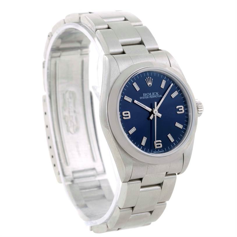 The image shows a Rolex Mid-Size 77080 Women's Stainless Steel Blue Dial 77080 Women's Stainless Steel Blue Dial Oyster Perpetual watch, angled to display the blue dial and stainless steel bracelet.