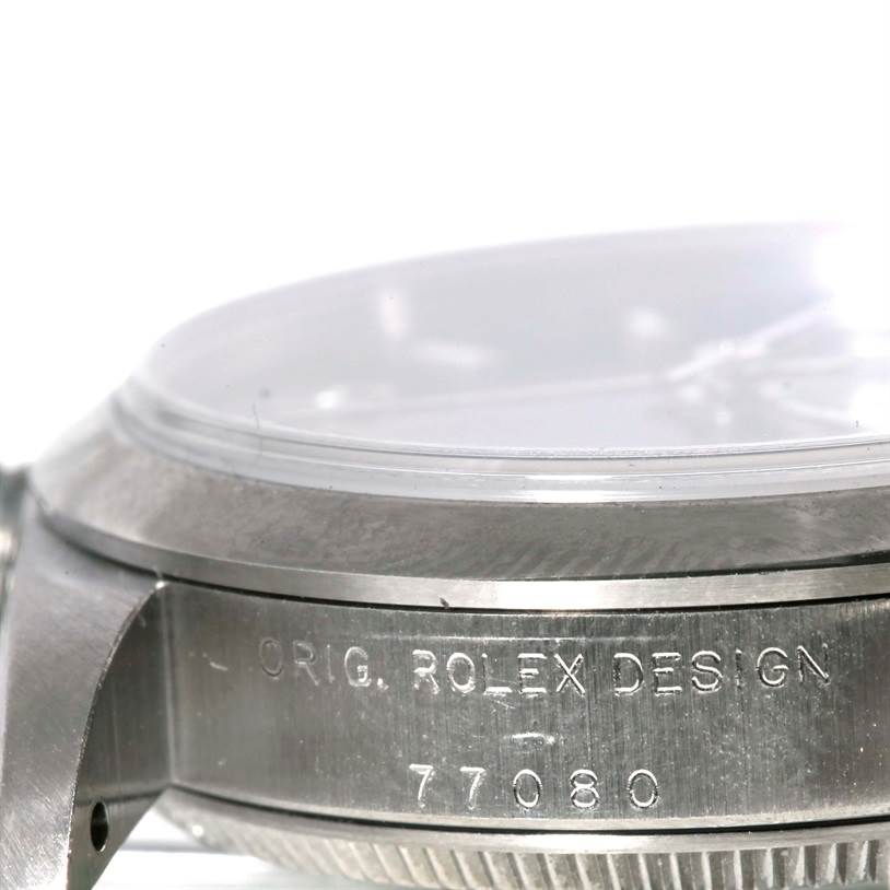 This image shows a close-up side view of a Mid-Size Rolex watch case, focusing on the bezel and engraved model number.
