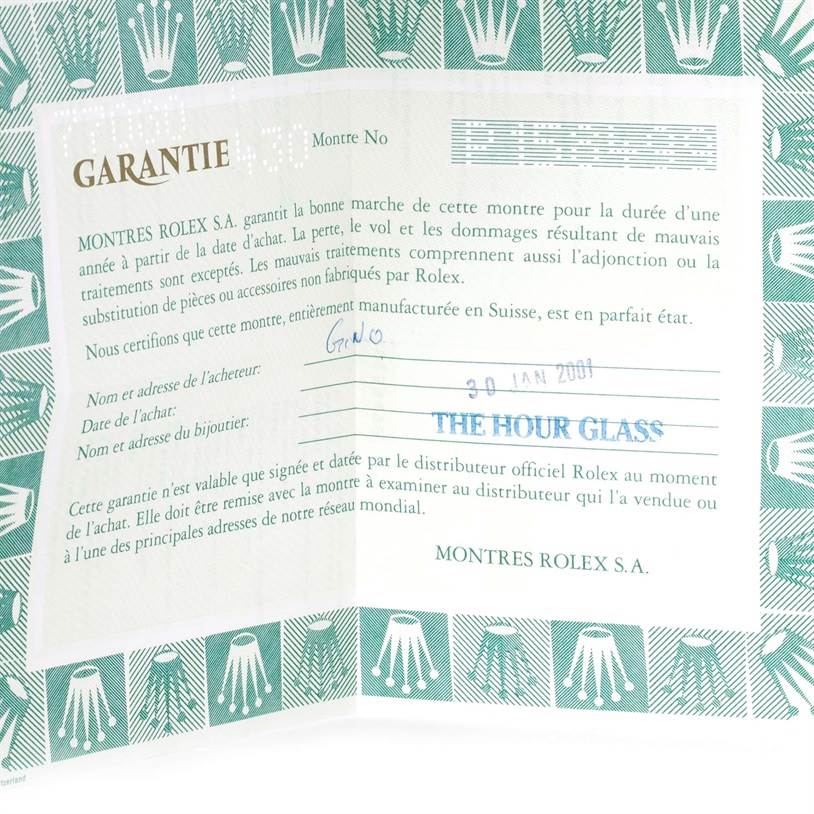 The image shows a warranty certificate for the Mid-Size model by Rolex, featuring text in French and the Rolex logo pattern around the edges.
