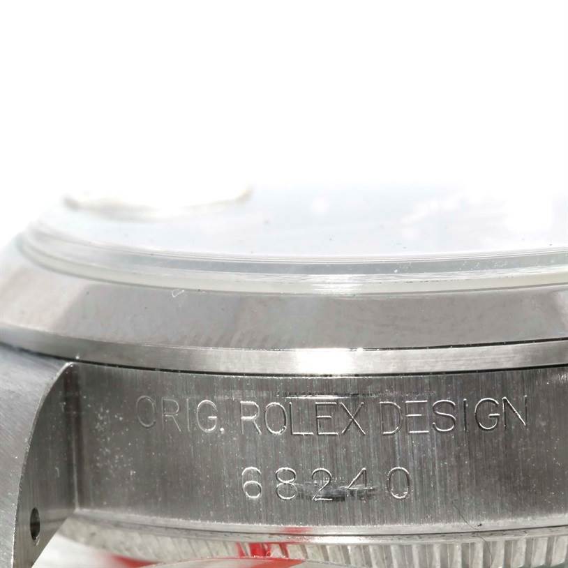 The image shows a close-up side view of the Rolex Mid-Size 68240 Women's Stainless Steel Blue Dial 68240 Women's Stainless Steel Blue Dial model, highlighting the watch case and engraved model number.