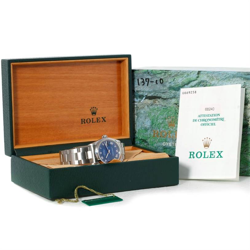 The image shows a Rolex Mid-Size 68240 Women's Stainless Steel Blue Dial 68240 Women's Stainless Steel Blue Dial watch in its open box, with a booklet and tags visible.