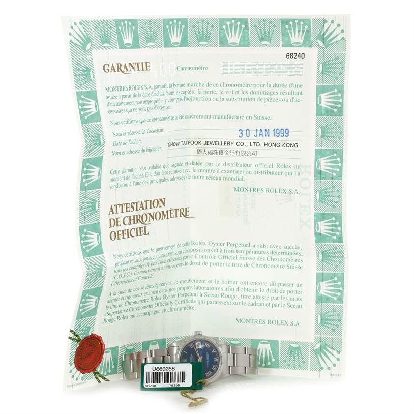 This image shows a Rolex Mid-Size 68240 Women's Stainless Steel Blue Dial 68240 Women's Stainless Steel Blue Dial model watch with its warranty card, facing front.