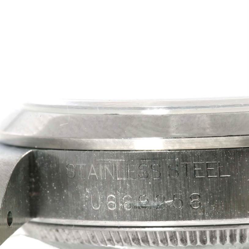 This close-up image shows the side of a Rolex Mid-Size 68240 Women's Stainless Steel Blue Dial 68240 Women's Stainless Steel Blue Dial watch, focusing on the stainless steel case and part of the bezel.