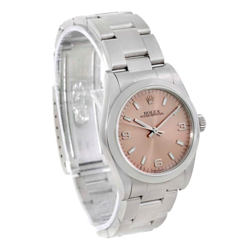 The Rolex Mid-Size 77080 Women's Stainless Steel Pink Dial 77080 Women's Stainless Steel Pink Dial Oyster Perpetual watch is shown at an angle highlighting the face, bezel, and bracelet.