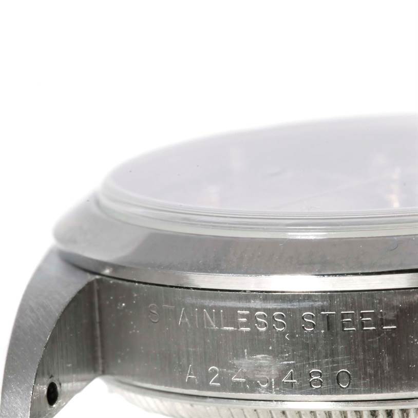 The image shows a close-up of the side of a Mid-Size Rolex watch, displaying the stainless steel band and serial number.