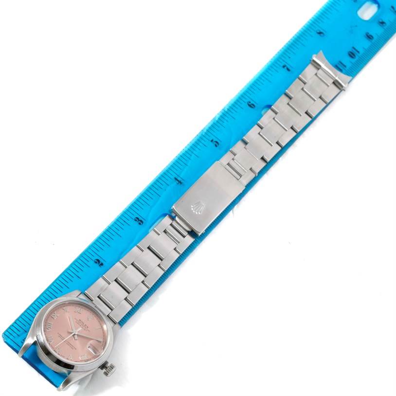 The Rolex Mid-Size 78240 Women's Stainless Steel Pink Dial 78240 Women's Stainless Steel Pink Dial watch is shown flat with its face, bracelet, and clasp visible, alongside a ruler for scale.