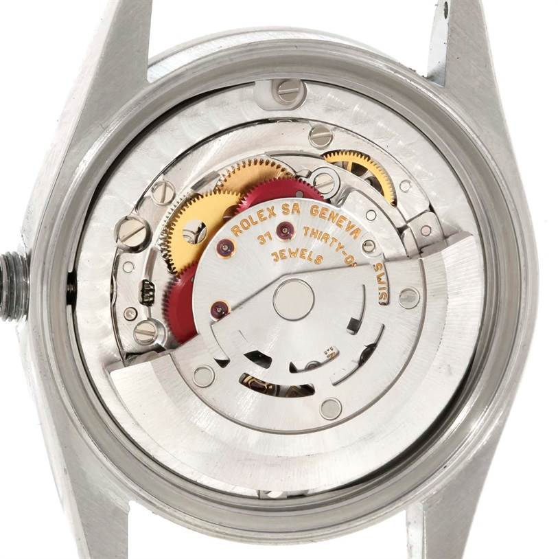 This image shows the inner mechanical movement of a Mid-Size Rolex watch.