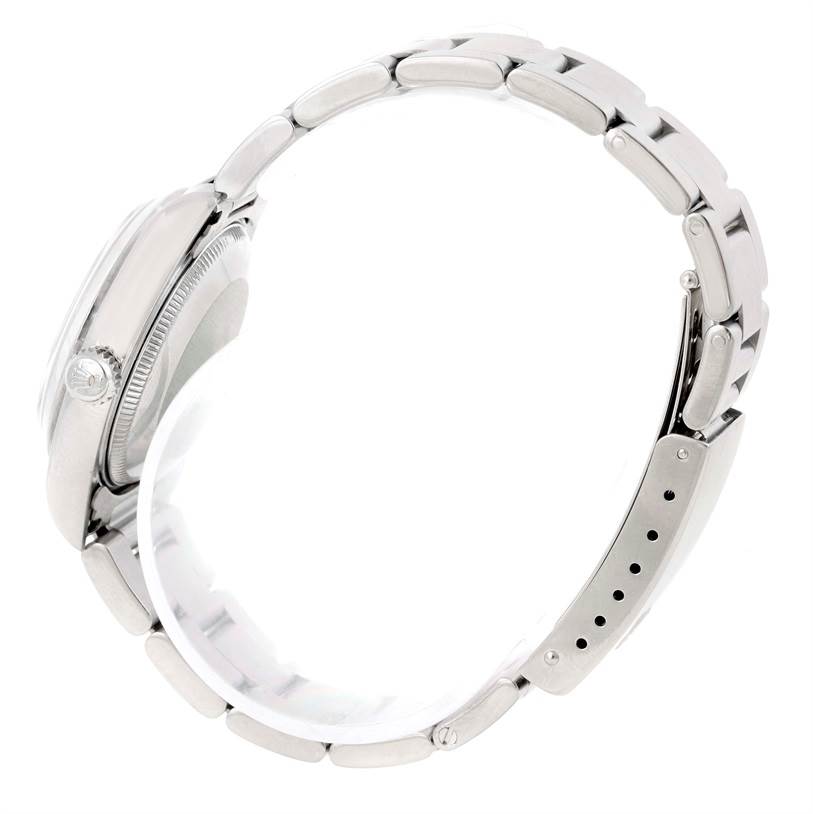 The image shows the side view of a Rolex Mid-Size 78240 Women's Stainless Steel Pink Dial 78240 Women's Stainless Steel Pink Dial model watch, focusing on its case, crown, and metal bracelet.