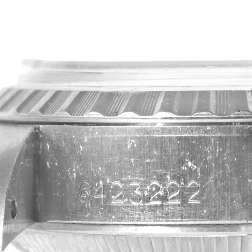 This image shows the side view of a Rolex Date 6924 Women's Stainless Steel Silver Dial 6924 Women's Stainless Steel Silver Dial model watch case, specifically focusing on the serial number engraving.