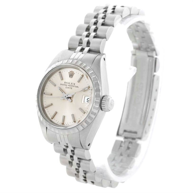 This image shows a Rolex Date 6924 Women's Stainless Steel Silver Dial 6924 Women's Stainless Steel Silver Dial model watch from a slight side angle, displaying the dial, bezel, crown, and part of the bracelet.