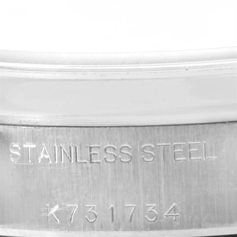 This image shows the serial number and "Stainless Steel" engraving on the case of a Rolex Date 79160 Women's Stainless Steel White Dial 79160 Women's Stainless Steel White Dial model watch.