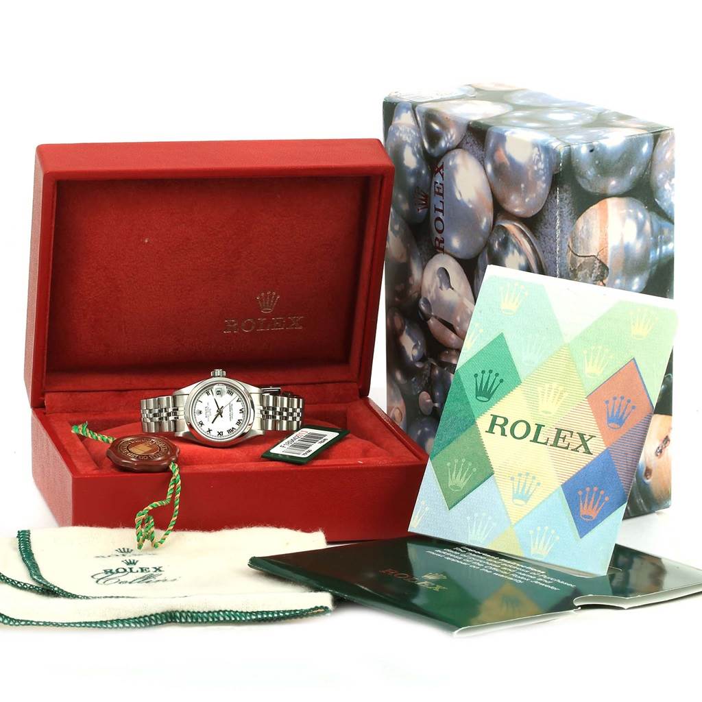 A Rolex Date 79160 Women's Stainless Steel White Dial 79160 Women's Stainless Steel White Dial model watch is shown at an angled front view with its box, manual, tag, cloth, and original packaging.
