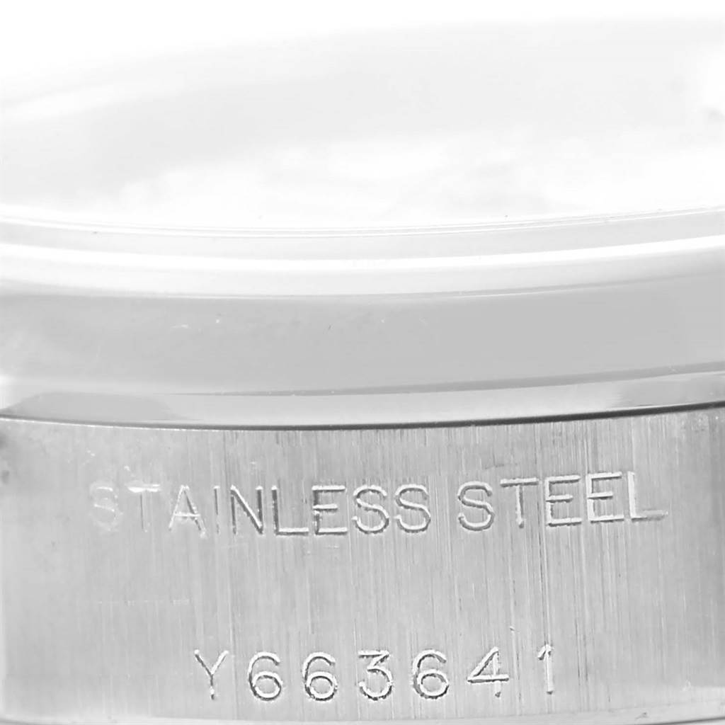 The image shows a close-up of the serial number and "Stainless Steel" engraving on the side of a Rolex Date 79160 Women's Stainless Steel White Dial 79160 Women's Stainless Steel White Dial model.