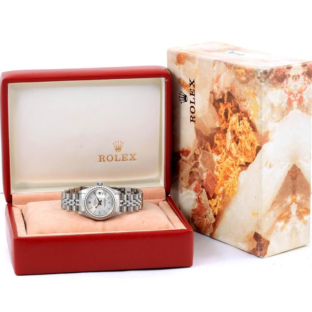 The image shows a Rolex Date 69240 Women's Stainless Steel Silver Dial 69240 Women's Stainless Steel Silver Dial model watch inside its open red box, with the watch bracelet and face visible, next to the original Rolex packaging.