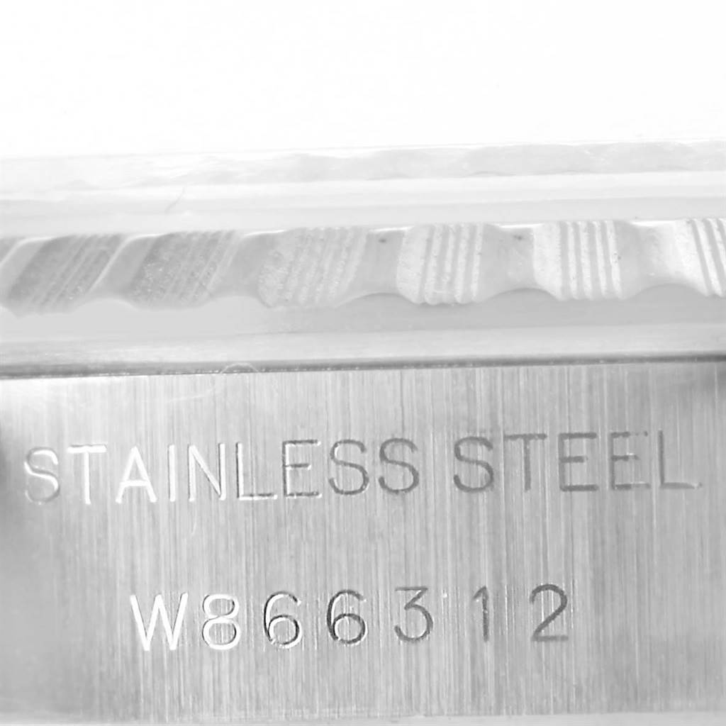 This image shows a close-up of the case side of a Rolex Date 69240 Women's Stainless Steel Silver Dial 69240 Women's Stainless Steel Silver Dial model, highlighting the stainless steel material and serial number.