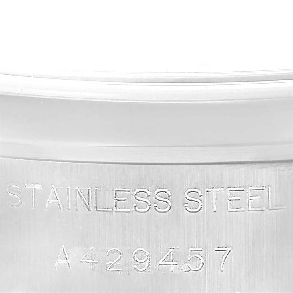 The image shows a close-up of the stainless steel case and serial number of a Rolex Date 69160 Women's Stainless Steel White Dial 69160 Women's Stainless Steel White Dial model watch.