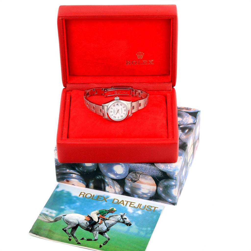 The image shows a Rolex Date 69160 Women's Stainless Steel White Dial 69160 Women's Stainless Steel White Dialjust watch in a red open box, with part of its bracelet visible, and a booklet placed in front of the box.