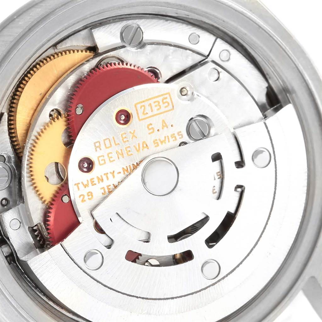 The image shows the movement mechanism of a Rolex Date 69240 Women's Stainless Steel Silver Dial 69240 Women's Stainless Steel Silver Dial model watch, focusing on gears and inscriptions.