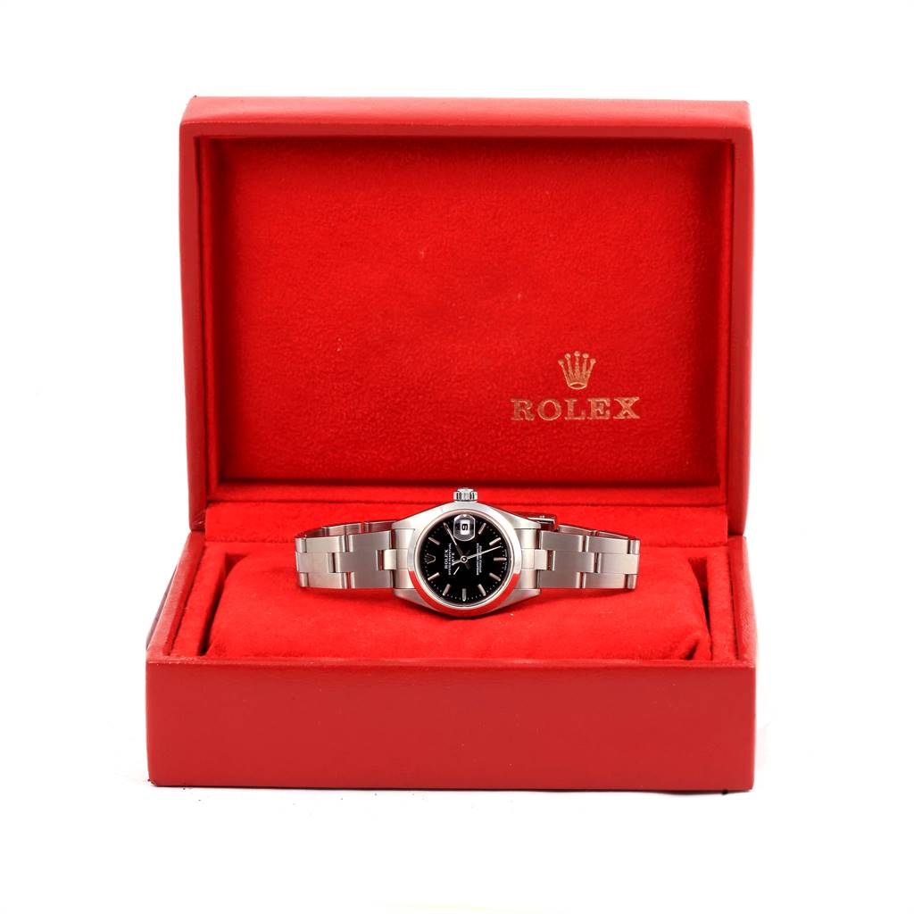 The image shows a Rolex Date 79160 Women's Stainless Steel Black Dial 79160 Women's Stainless Steel Black Dial model watch with a black dial and silver band in a red Rolex box.