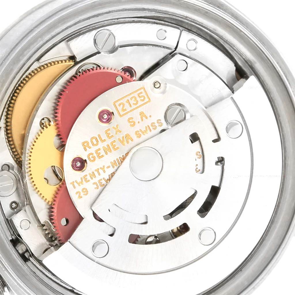 This image shows a close-up view of the movement mechanism inside a Rolex Date 69160 Women's Stainless Steel Pink Dial 69160 Women's Stainless Steel Pink Dial model watch, displaying gears and jewels.