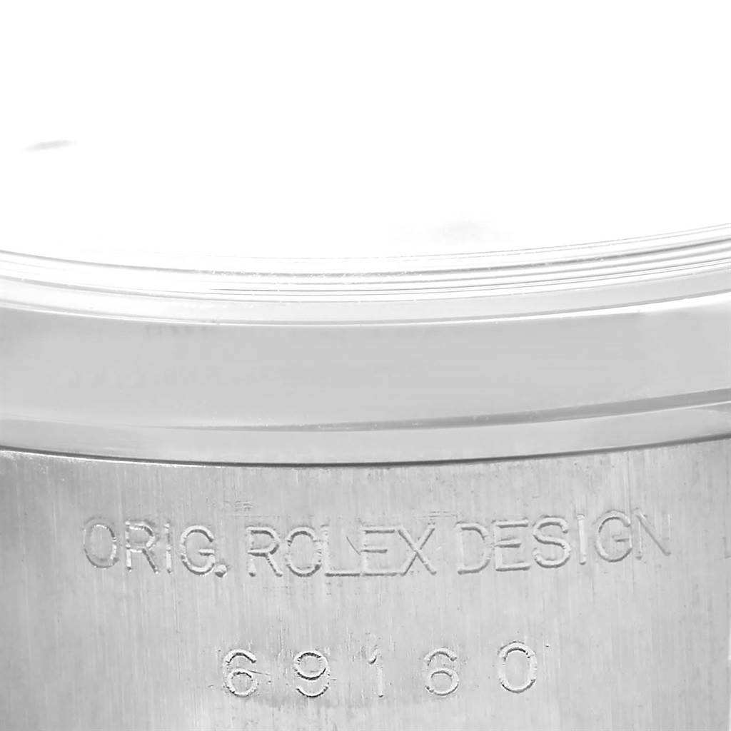 This image shows a close-up of the side case of the Rolex Date 69160 Women's Stainless Steel Pink Dial 69160 Women's Stainless Steel Pink Dial model with the engraved design and model number.