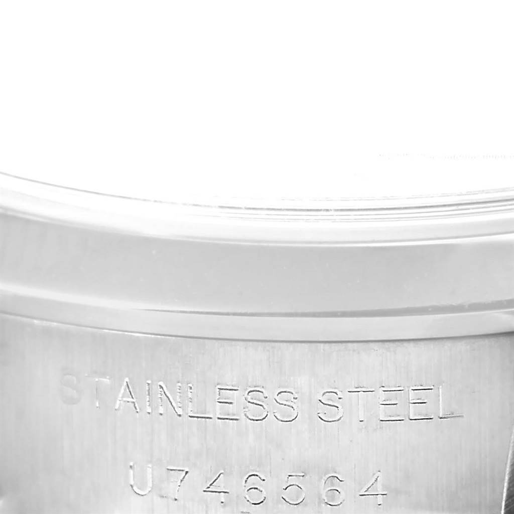 The image shows a close-up of the stainless steel case back of a Rolex Date 69160 Women's Stainless Steel Pink Dial 69160 Women's Stainless Steel Pink Dial model watch with visible serial numbers.